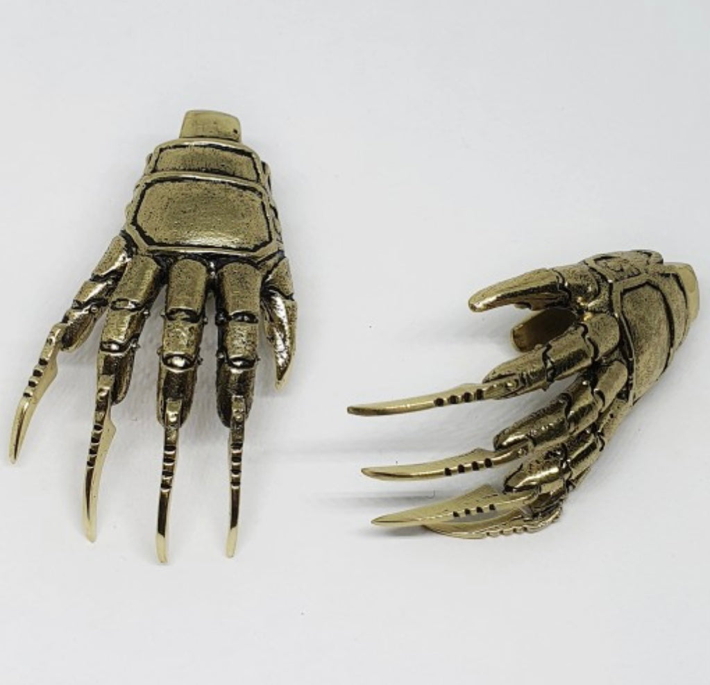 Brass Freddy Krueger ear weights showing intricate glove detail, 40-46g per piece, only 80 pairs worldwide